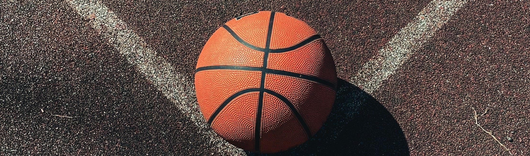 Basketball on corner of oudoor court
